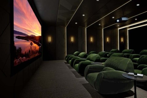 A luxurious home theater with three rows of seats.