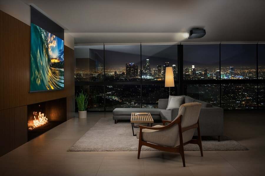 A luxury media room with a floor-to-ceiling window overseeing the city.