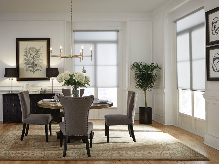 Two dining room windows featuring Lutron motorized shades.