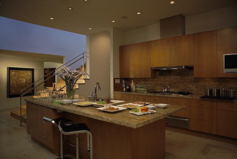 A luxury kitchen space with in-ceiling light fixtures.