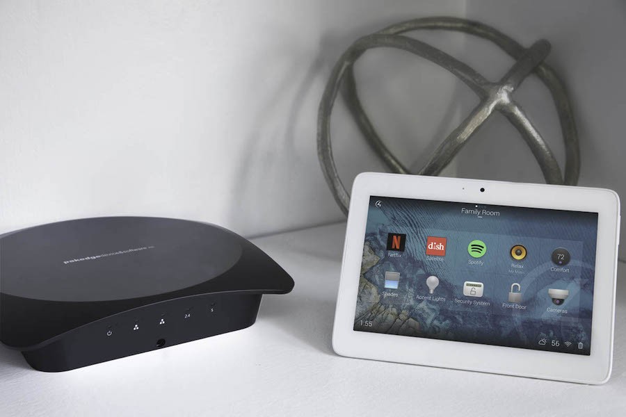 Pakedge networking device next to a Control4 smart home automation tablet