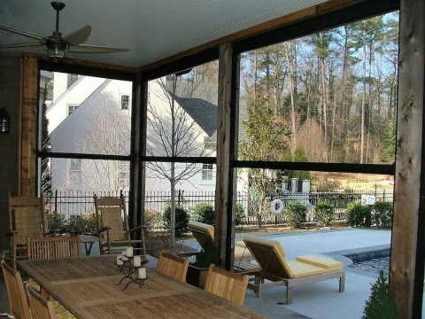 Progressive Screens insect screen on a patio with a table and pool seating
