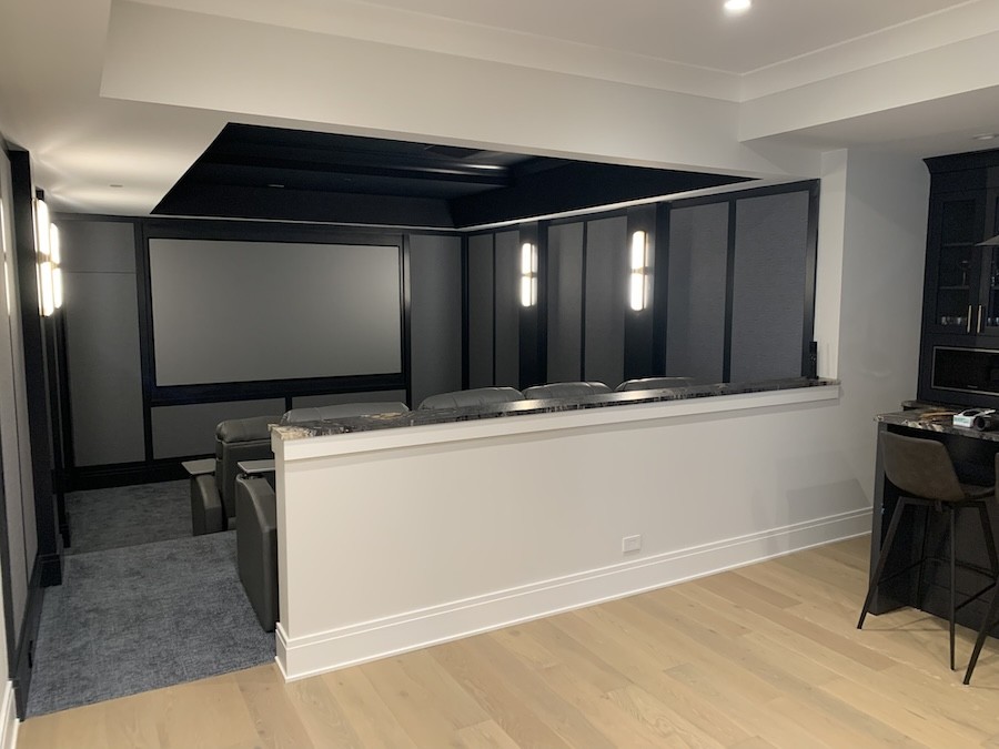  custom home theater space with an open area for recreation near the back of the room