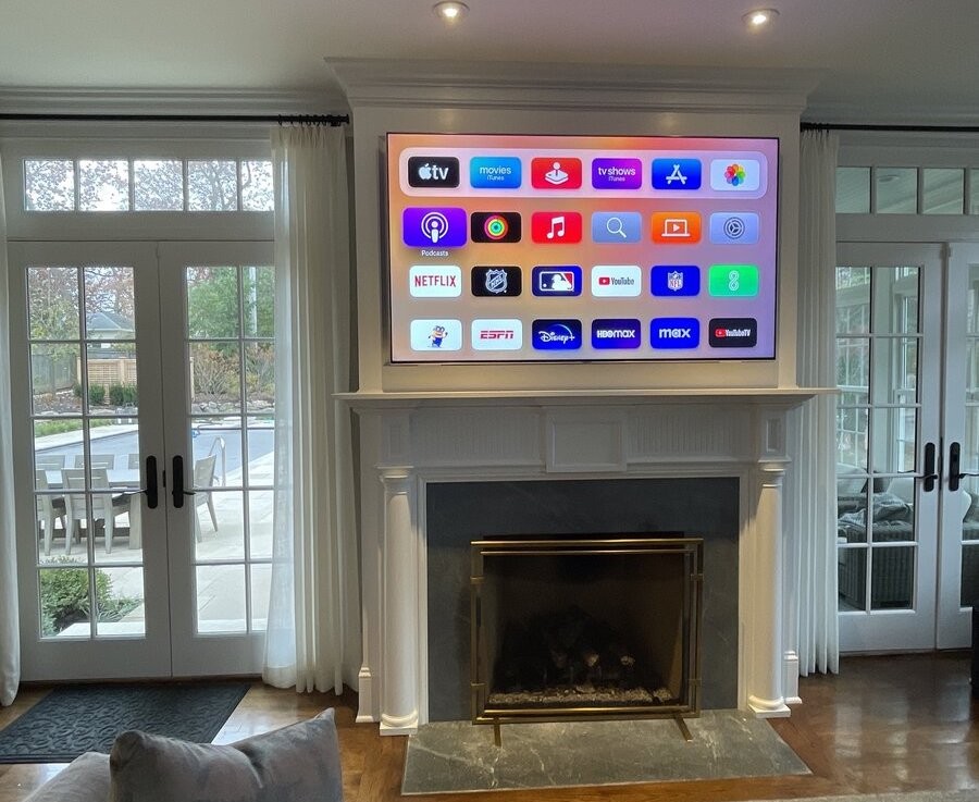 A media setup with a TV installed above the fireplace