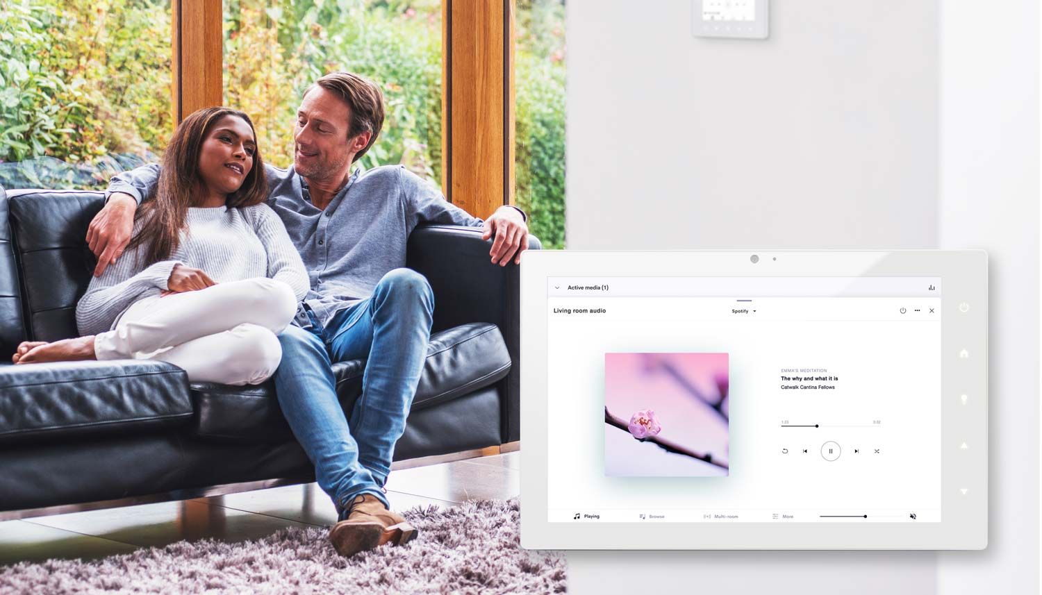 couple listening to music on a couch with a white touchpanel product overlay